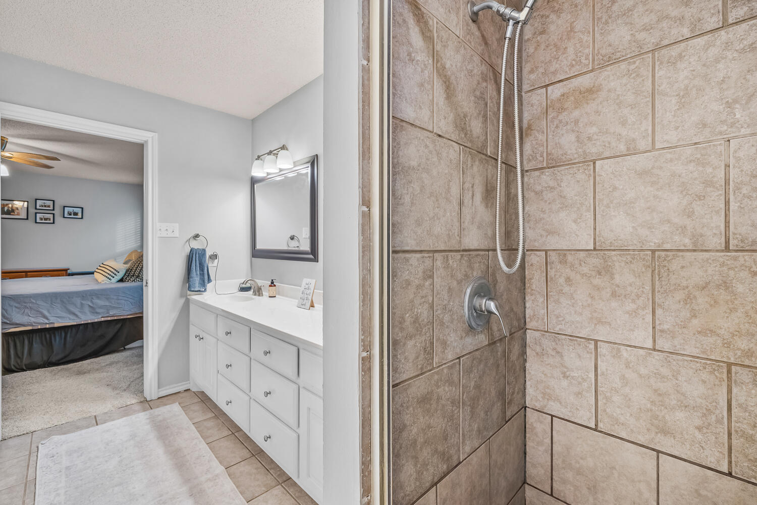 10607 Dover Avenue Lubbock, TX 79424 - Photo 22 of 34 a bathroom with a double vanity sink and mirror