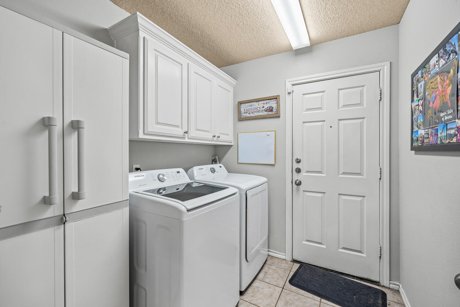 10607 Dover Avenue Lubbock, TX 79424 - Photo 24 of 34 a utility room with cabinets washer and dryer