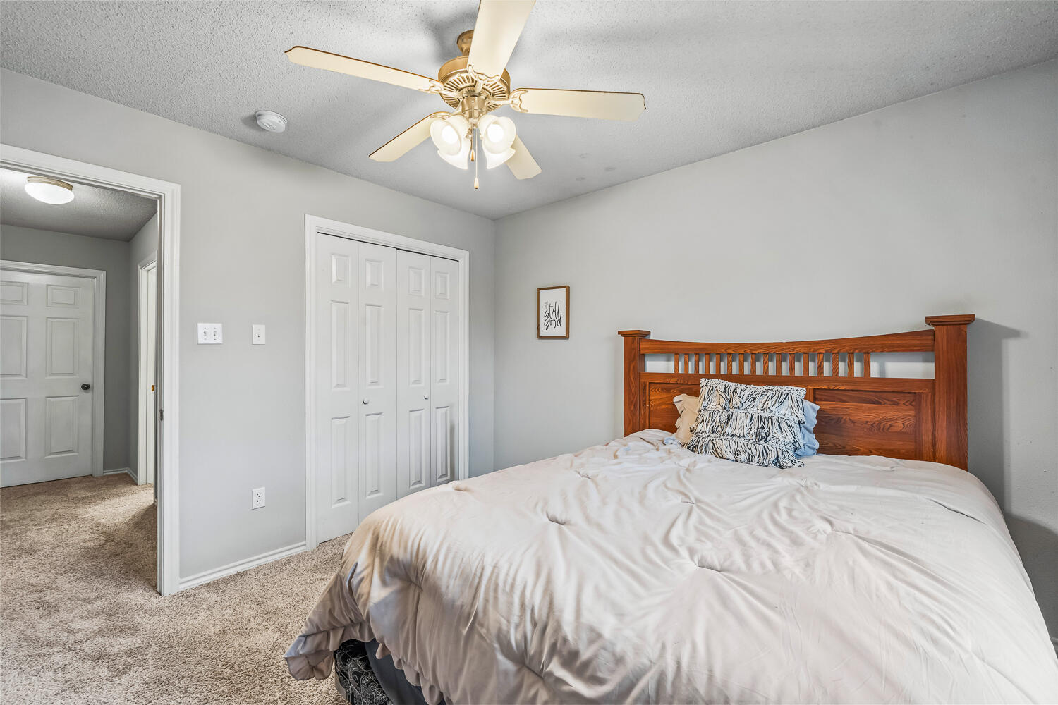 10607 Dover Avenue Lubbock, TX 79424 - Photo 26 of 34 a bedroom with a large bed and a chandelier