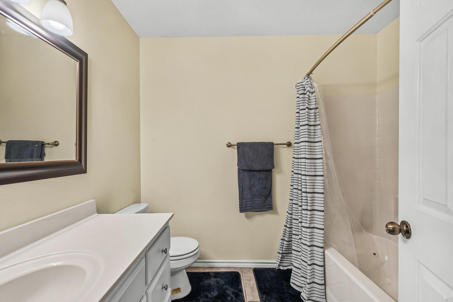10607 Dover Avenue Lubbock, TX 79424 - Photo 28 of 34 a bathroom with a sink toilet and shower