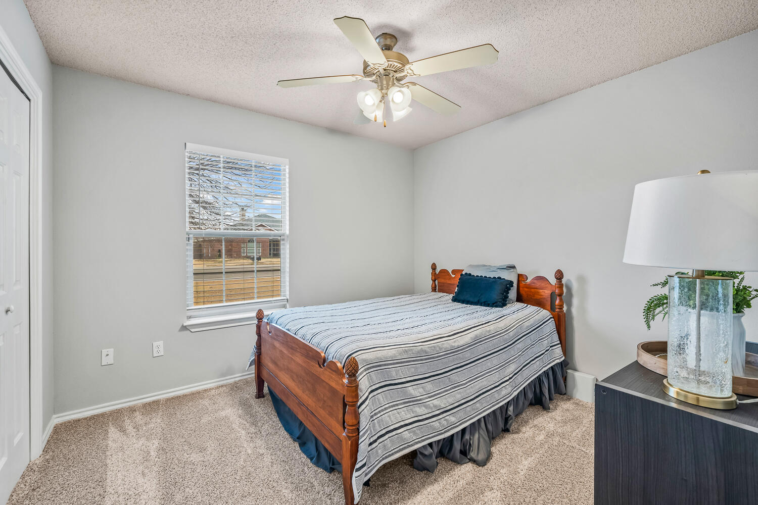 10607 Dover Avenue Lubbock, TX 79424 - Photo 29 of 34 a bed room with a bed and a chandelier