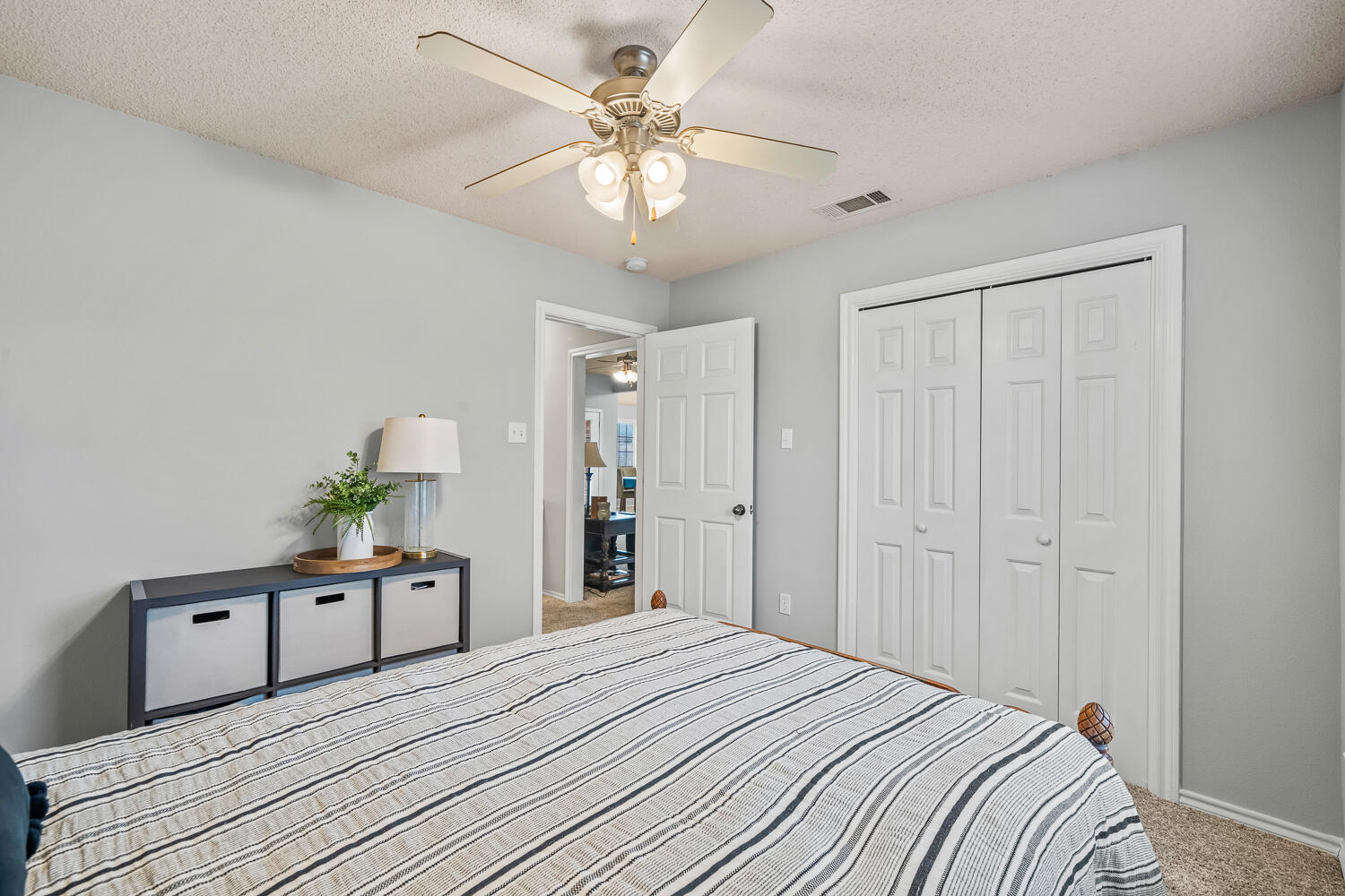 10607 Dover Avenue Lubbock, TX 79424 - Photo 30 of 34 a bedroom with a bed and a chandelier
