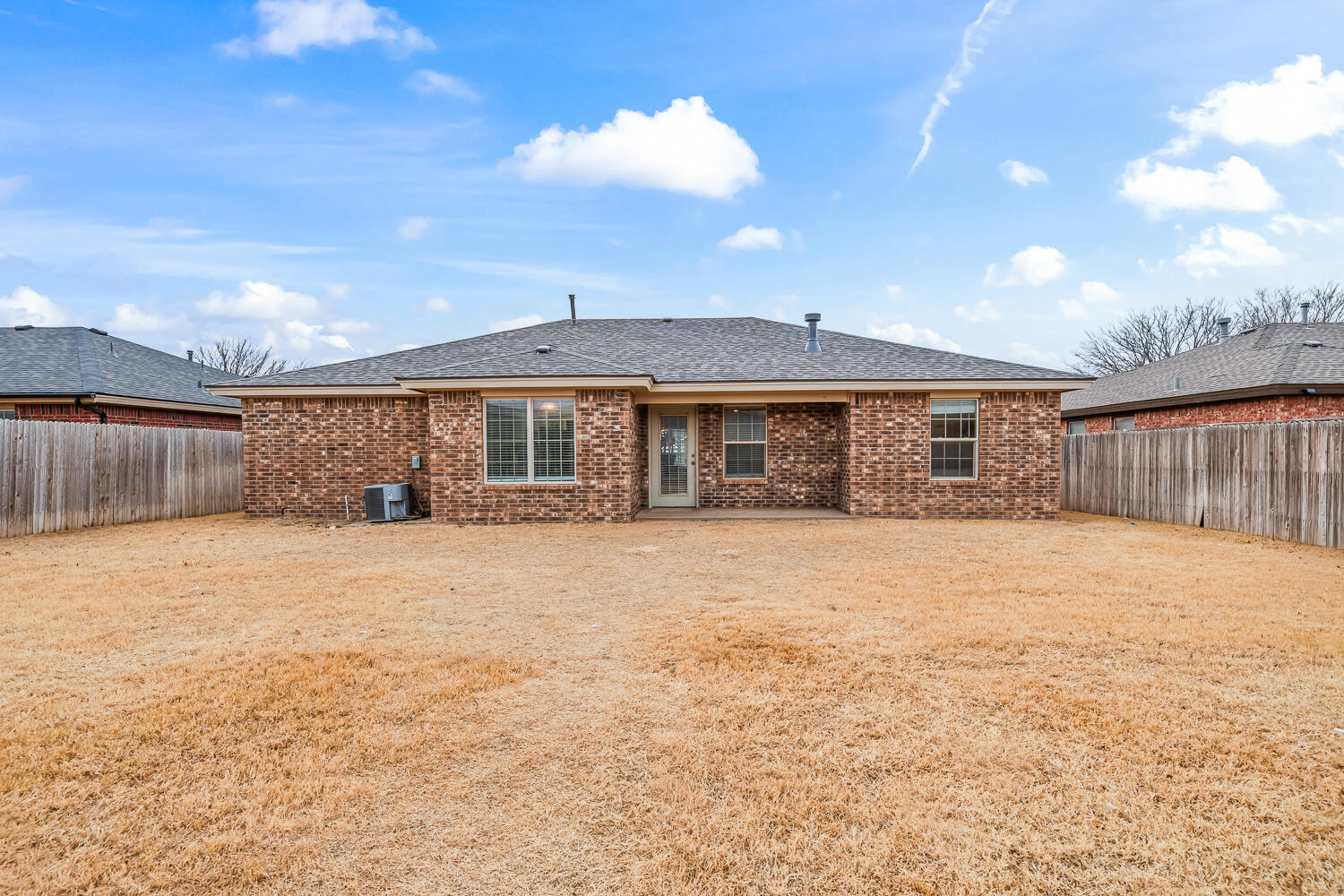 10607 Dover Avenue Lubbock, TX 79424 - Photo 33 of 34 a front view of a house with a yard and garage