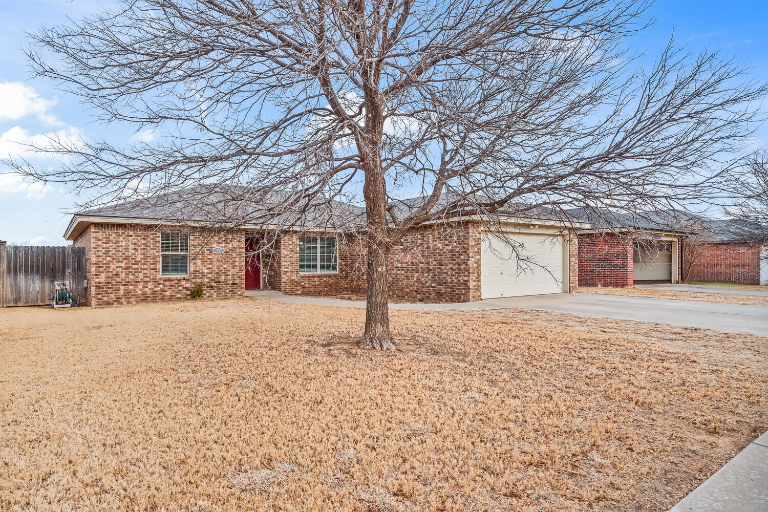 10607 Dover Avenue Lubbock, TX 79424 - Photo 4 of 34 a front view of a house with a yard and garage