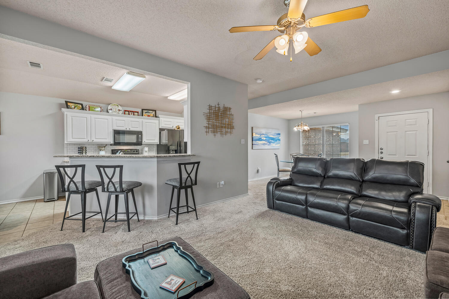 10607 Dover Avenue Lubbock, TX 79424 - Photo 5 of 34 a living room with furniture a table and kitchen view