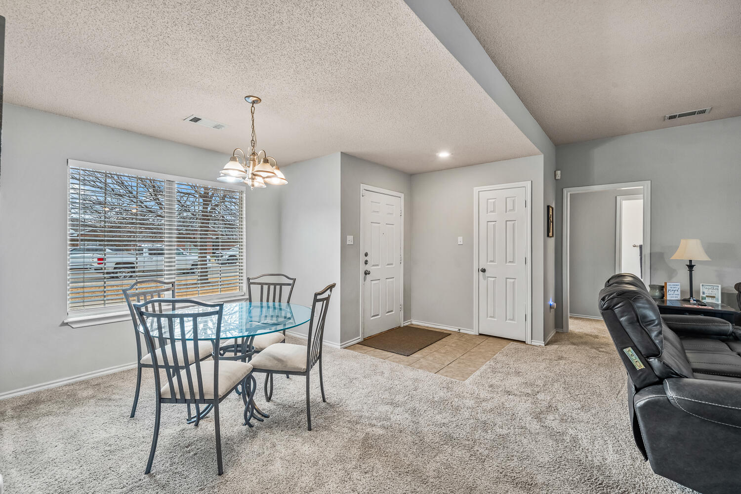 10607 Dover Avenue Lubbock, TX 79424 - Photo 7 of 34 a dining room with furniture a chandelier and window