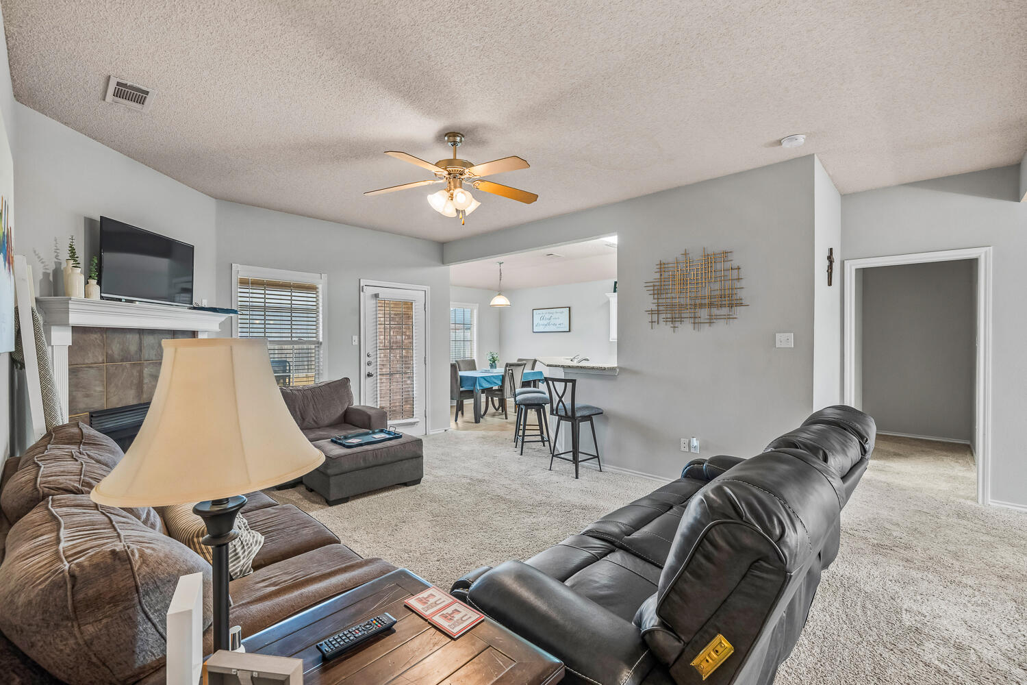 10607 Dover Avenue Lubbock, TX 79424 - Photo 8 of 34 a living room with furniture and a flat screen tv
