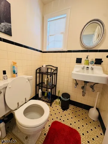 a bathroom with a sink toilet mirror and vanity