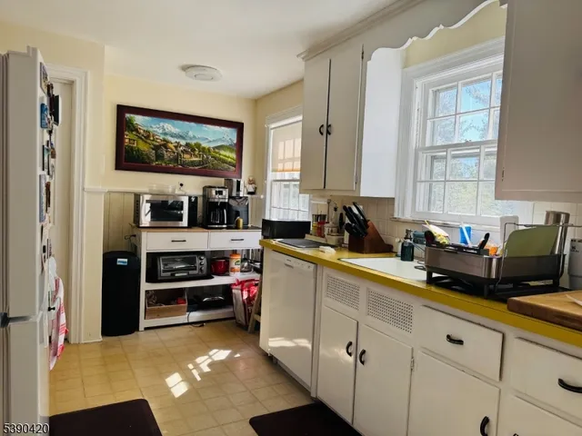 a kitchen with stainless steel appliances a sink and a microwave