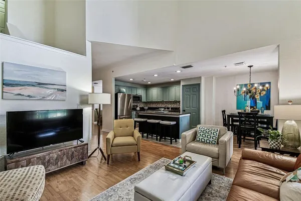 a kitchen with stainless steel appliances granite countertop a refrigerator a stove top oven a sink and dishwasher