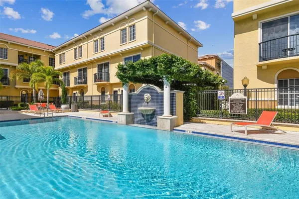 a view of a house with pool and sitting area