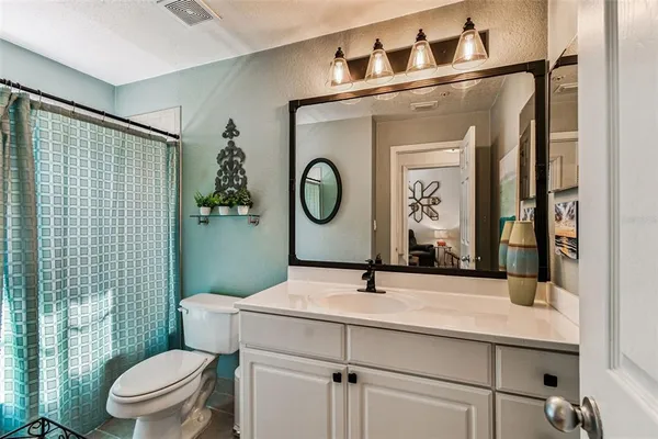 a en suite bathroom with a sink and a mirror