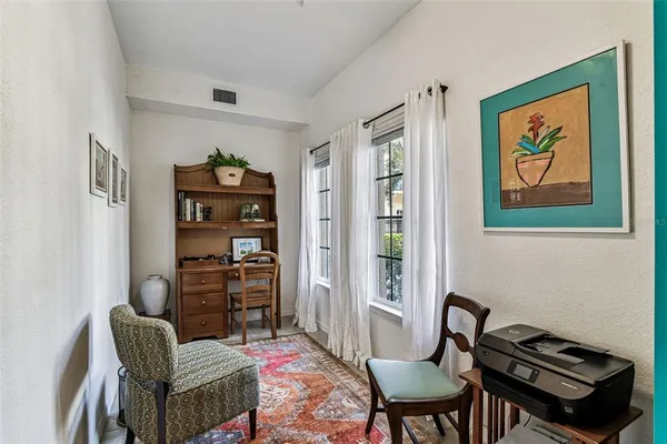 a living room with furniture a lamp and a window