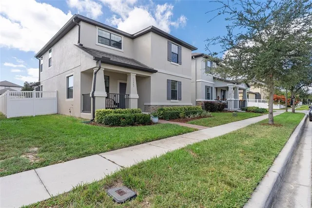 a front view of a house with a garden and plants