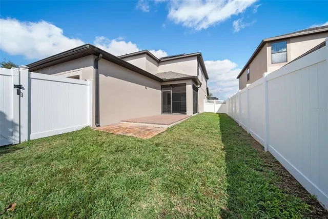 a view of white house with a yard and garage