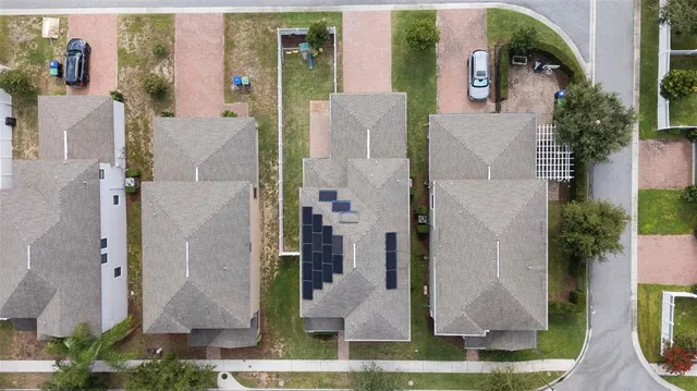 an aerial view of multiple houses with a yard