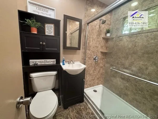 a bathroom with a sink mirror toilet and shower