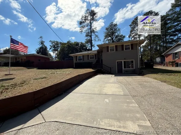 a view of a house with a wooden deck