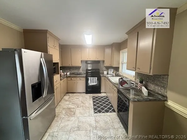 a kitchen with a refrigerator sink and microwave