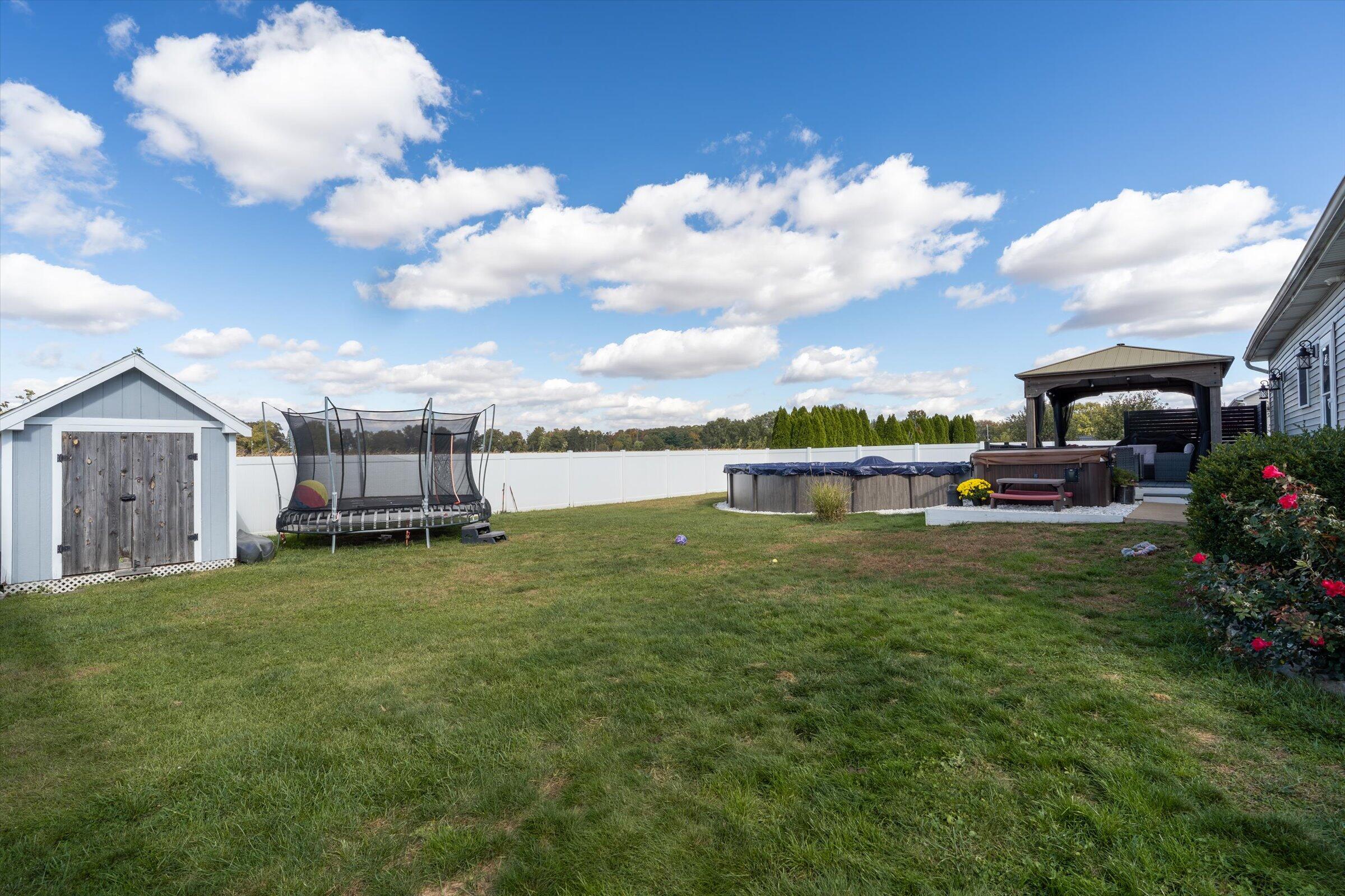 408 Coyote Trail Kouts, IN 46347 - Photo 33 of 36 a view of a garden with a building in the background