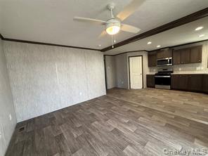 2898 Rte 9W New Windsor, NY 12553 - Photo 4 of 14 Kitchen with appliances with stainless steel finishes, dark brown cabinetry, light countertops, dark wood-style flooring, and a ceiling fan