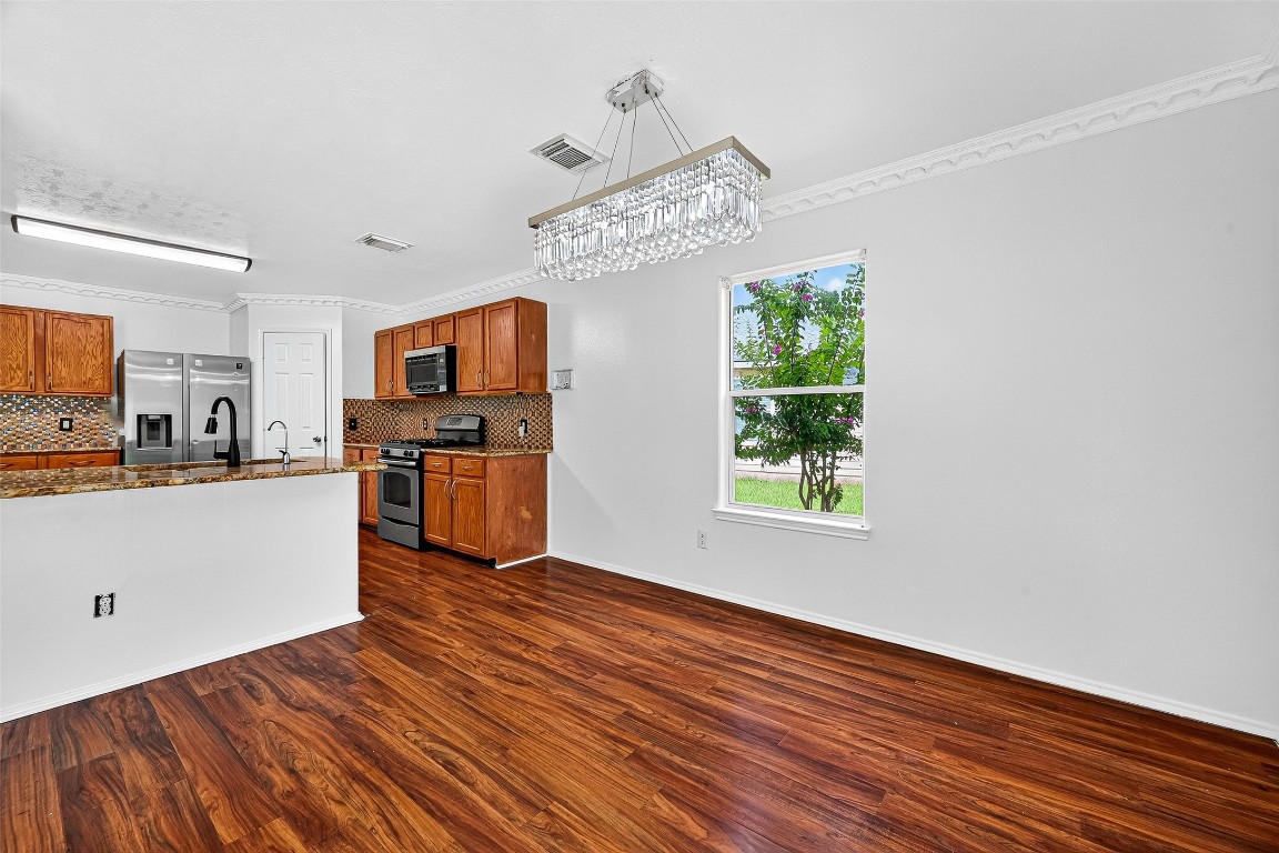 634 Hawthorne Pasture Road Rosenberg, TX 77471 - Photo 14 of 49 a view of kitchen with wooden floor electronic appliances and window