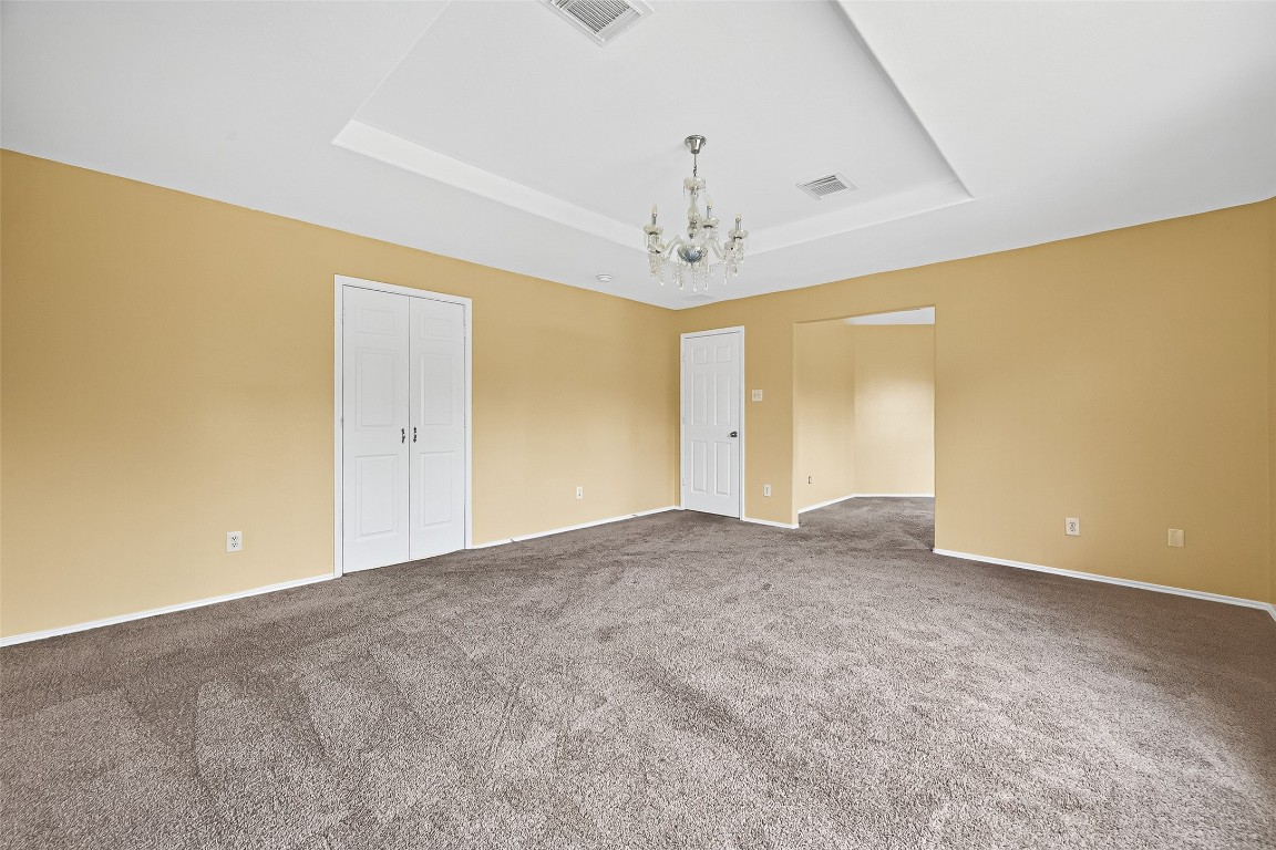 634 Hawthorne Pasture Road Rosenberg, TX 77471 - Photo 38 of 49 a view of an empty room with a chandelier fan