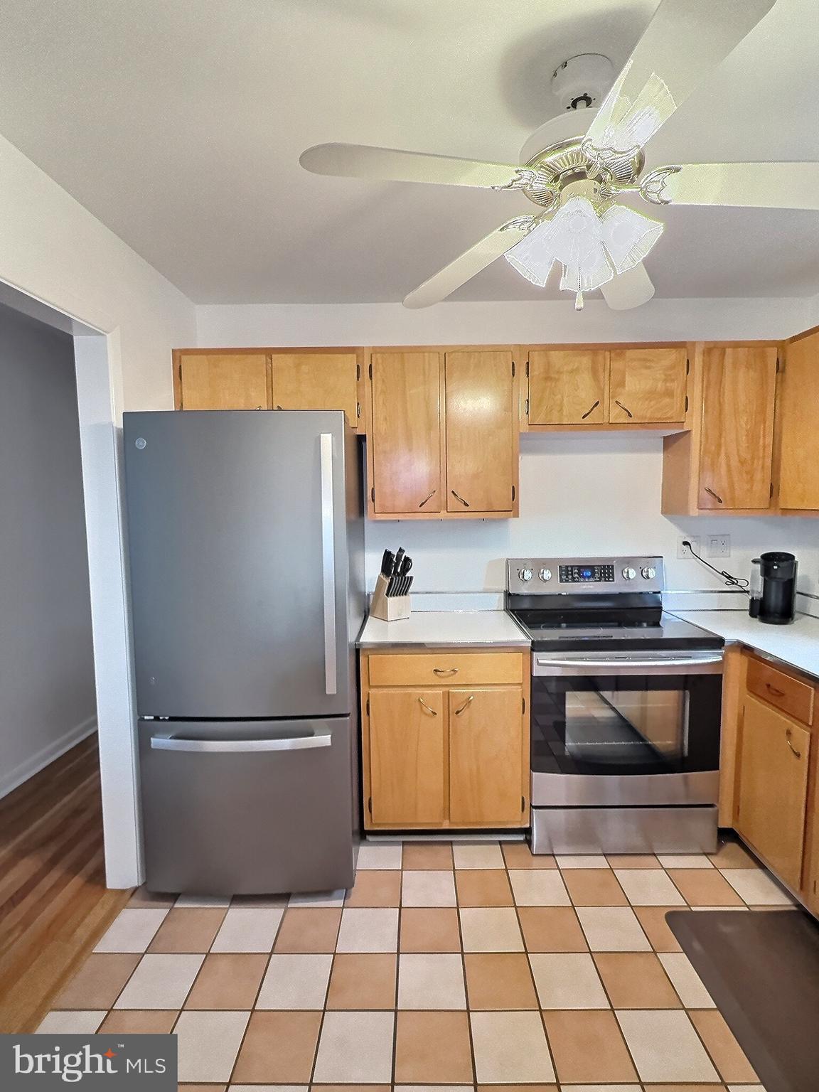 6639 Bucknell Road Bryans Road, MD 20616 - Photo 23 of 28 a kitchen with a refrigerator a stove a sink and a counter top space