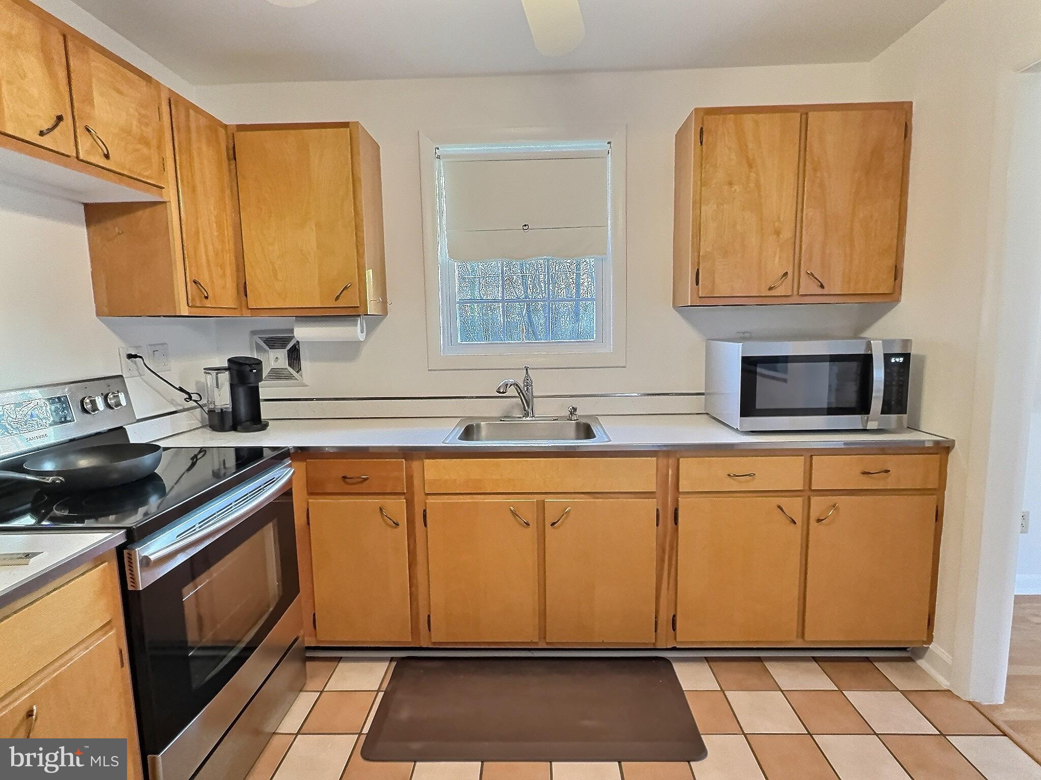 6639 Bucknell Road Bryans Road, MD 20616 - Photo 24 of 28 a kitchen with stainless steel appliances granite countertop a sink stove and cabinets
