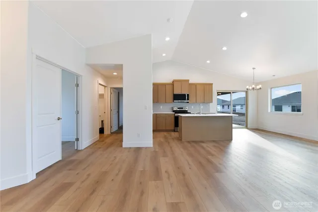 a large kitchen with stainless steel appliances kitchen island a large counter top and a stove top oven