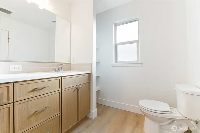 a bathroom with a sink toilet and vanity