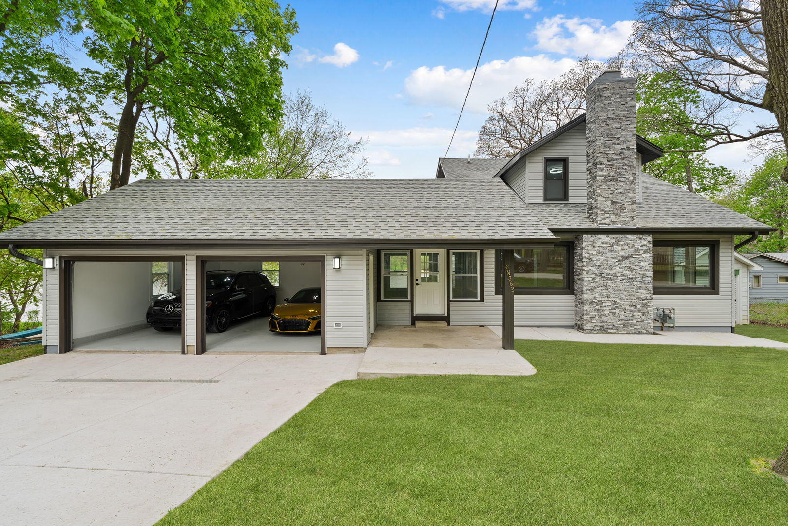 a view of a house with a yard and sitting area