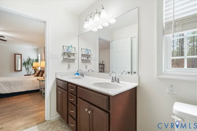 a en suite bathroom with a sink double vanity and a mirror