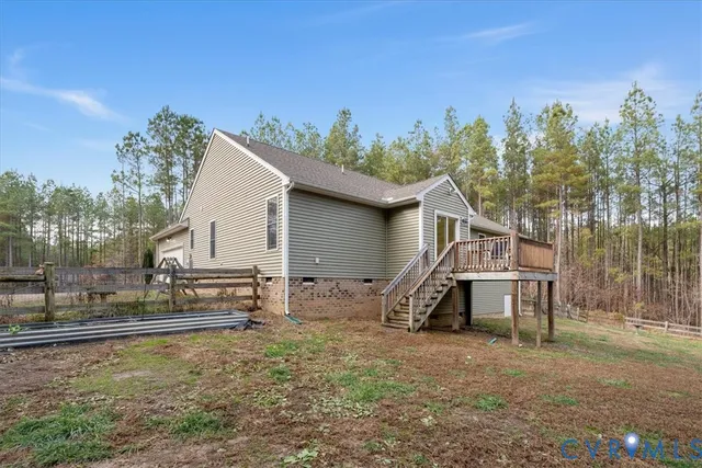 a view of a house with a yard and a wooden fence