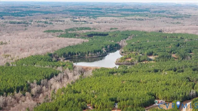 an aerial view of residential houses with outdoor space and trees