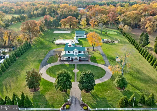 an aerial view of a residential houses with outdoor space and street view