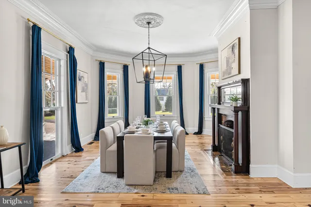 a kitchen with stainless steel appliances granite countertop a stove a sink dishwasher and a refrigerator with wooden floor