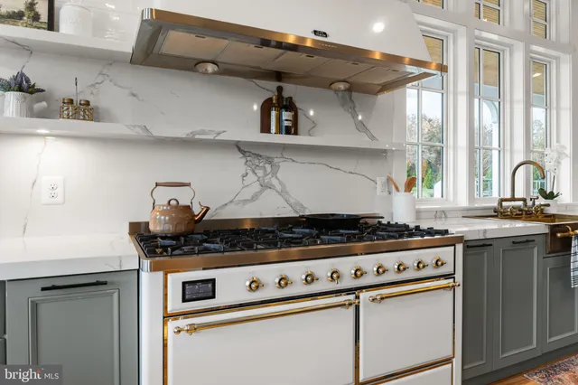 a spacious bedroom with a bed and a chandelier