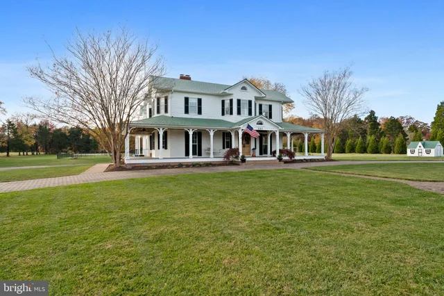 a view of a house with backyard porch and sitting area