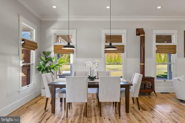 an aerial view of residential houses with outdoor space and trees