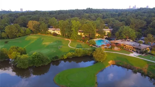 an aerial view of a house with a garden and lake view