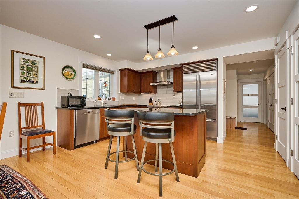 23 Ford Crossing Northampton, MA 01060 - Photo 4 of 34 a kitchen with stainless steel appliances granite countertop a stove a sink dishwasher and a refrigerator with wooden floor