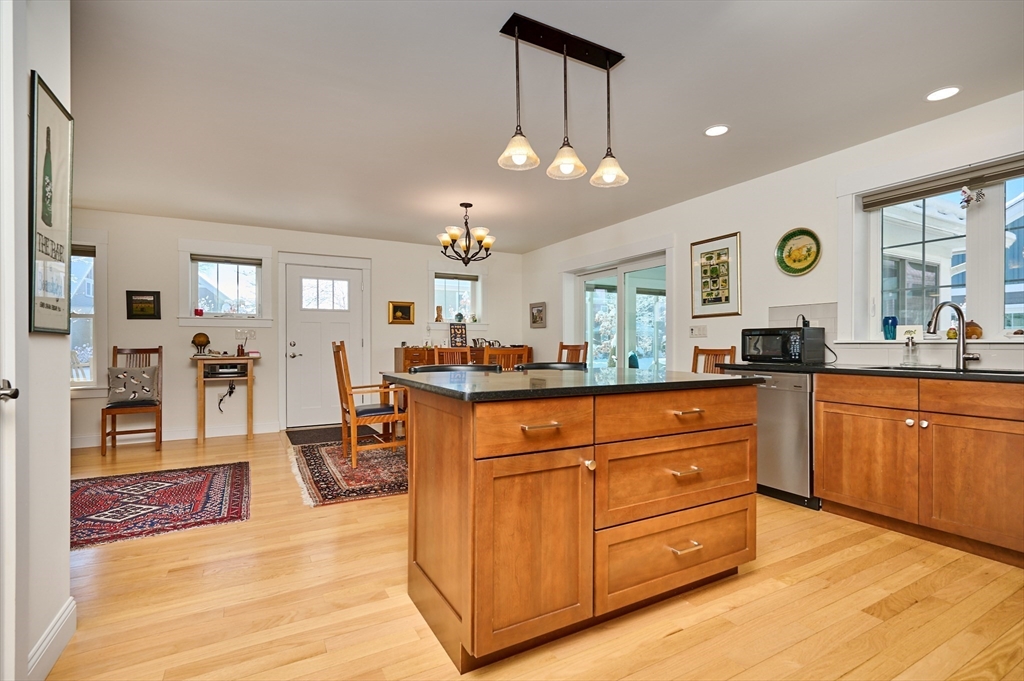 23 Ford Crossing Northampton, MA 01060 - Photo 6 of 34 a large kitchen with stainless steel appliances granite countertop a stove a sink dishwasher and a dining table with the living room view