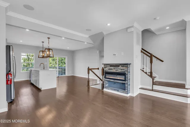 a view of kitchen with microwave stove and wooden floor