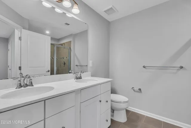 a bathroom with a sink double vanity and a mirror