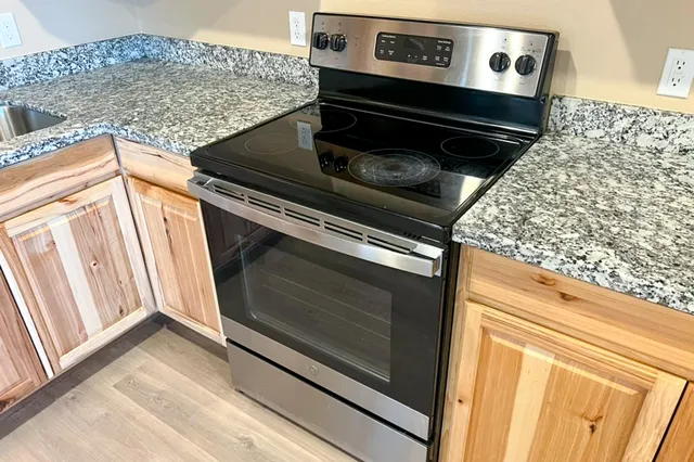 a stove top oven sitting inside of a kitchen