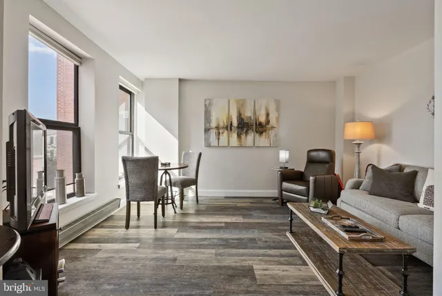 a living room with furniture and a lamp