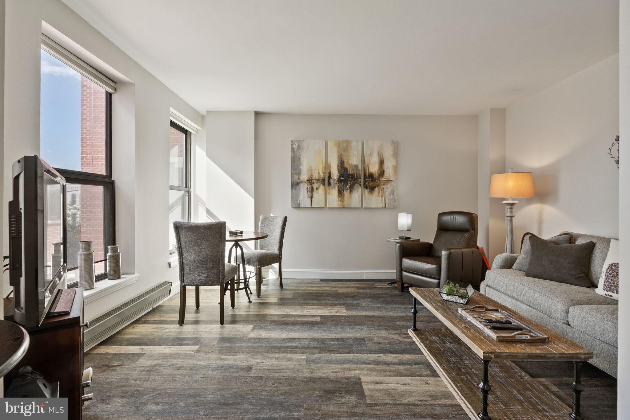 649 C Street Southeast, Unit 304 Washington, DC 20003 - Photo 1 of 37 a living room with furniture and a lamp