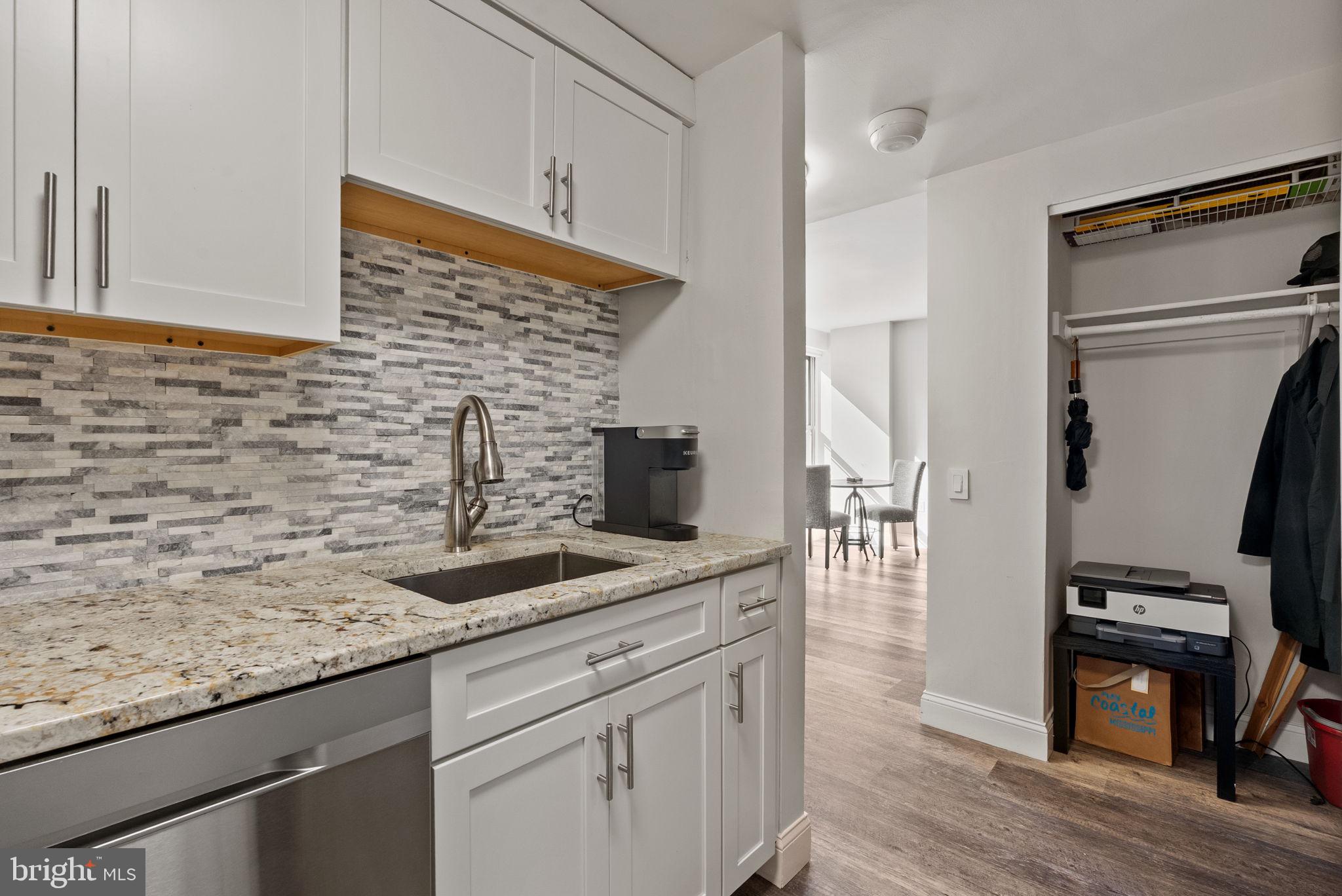 649 C Street Southeast, Unit 304 Washington, DC 20003 - Photo 13 of 37 a kitchen with stainless steel appliances granite countertop a sink stove and refrigerator