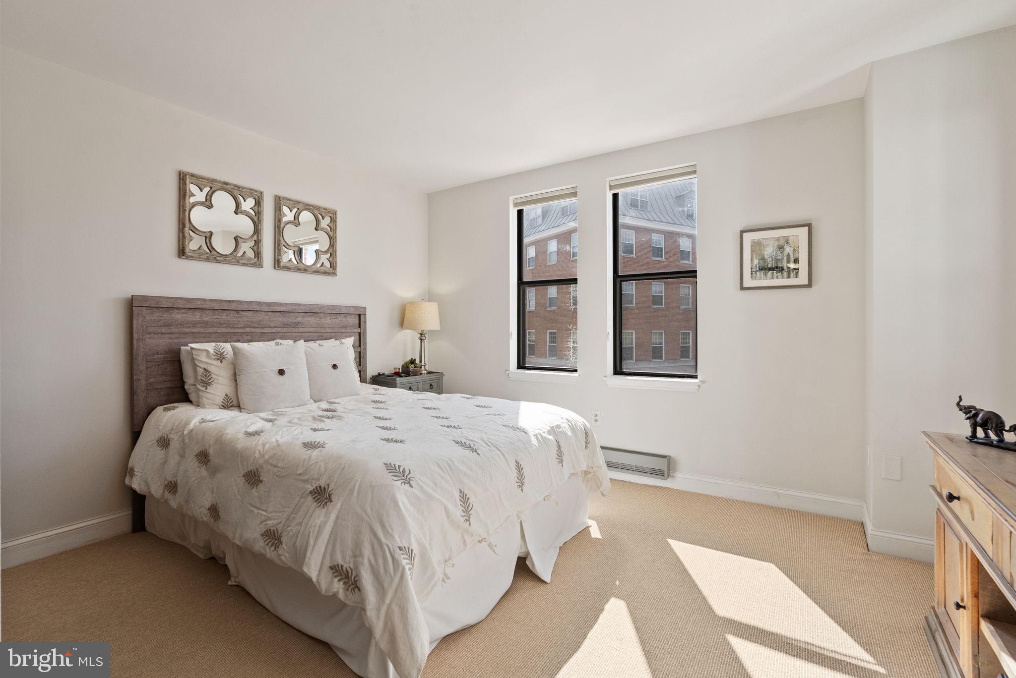 649 C Street Southeast, Unit 304 Washington, DC 20003 - Photo 15 of 37 a bedroom with a bed and a lamp on dresser